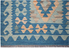 Handwoven Afghan Maimana wool runner featuring a blue background with geometric patterns.