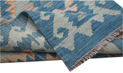 A handwoven Afghan Maimana kilim runner featuring a blue and beige geometric pattern.