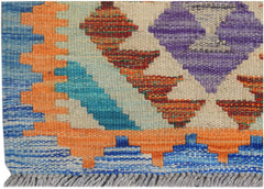 Handmade Afghan Maimana kilim runner featuring vibrant geometric patterns in wool.