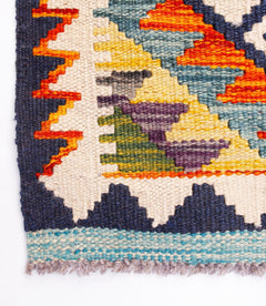Handwoven Afghan Maimana wool kilim runner featuring a geometric pattern in vibrant colors.