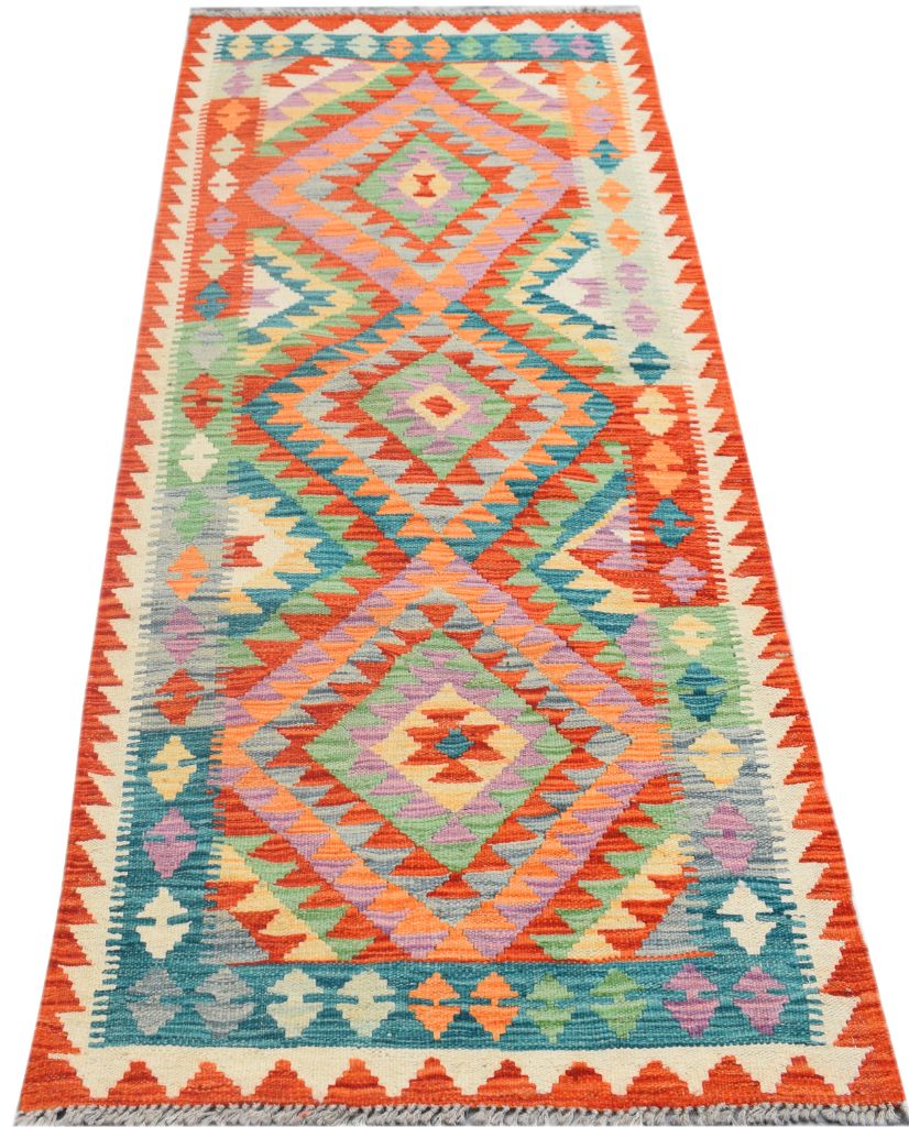 A handmade Afghan Maimana wool runner rug featuring a vibrant geometric diamond pattern.