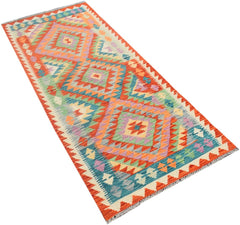 A handmade Afghan Maimana runner rug featuring a vibrant geometric diamond pattern in wool.