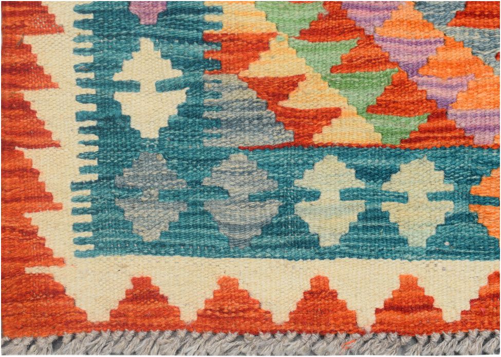 Handmade Afghan Maimana kilim runner featuring a geometric pattern in vibrant multicolored wool.