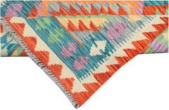 A handmade Afghan Maimana kilim runner featuring vibrant geometric patterns in wool.