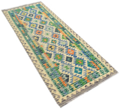 A handmade Afghan Maimana wool runner rug featuring a colorful geometric pattern.