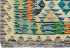 A handmade Afghan Maimana kilim runner featuring a geometric pattern in vibrant, multicolored wool.