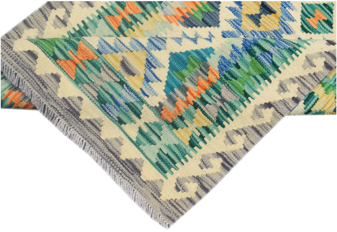 A handmade Afghan Maimana kilim runner featuring a vibrant geometric pattern in wool.