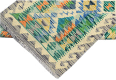A handmade Afghan Maimana kilim runner featuring a vibrant geometric pattern in wool.