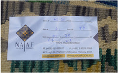 An Afghan Maimana Kilim runner featuring a geometric pattern in rich, multicolored wool.