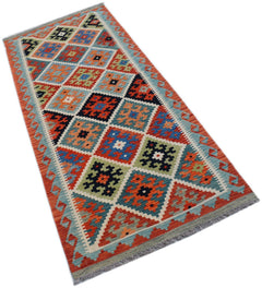 Handwoven Afghan Maimana wool runner rug featuring a colorful geometric diamond pattern.