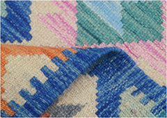 A handmade Afghan Maimana kilim runner featuring a vibrant geometric pattern in wool.