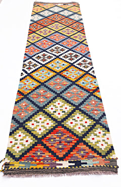Handwoven Afghan Maimana wool runner featuring a colorful geometric diamond pattern.