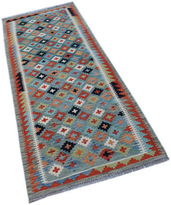 Handwoven Afghan Maimana wool runner rug featuring a colorful geometric pattern on a blue field.