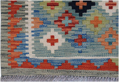 Handwoven Afghan Maimana wool runner featuring a geometric pattern in vibrant multi-colored tones.