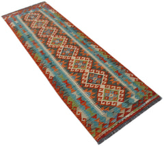 A handmade Afghan Maimana wool runner rug featuring a colorful geometric diamond pattern.