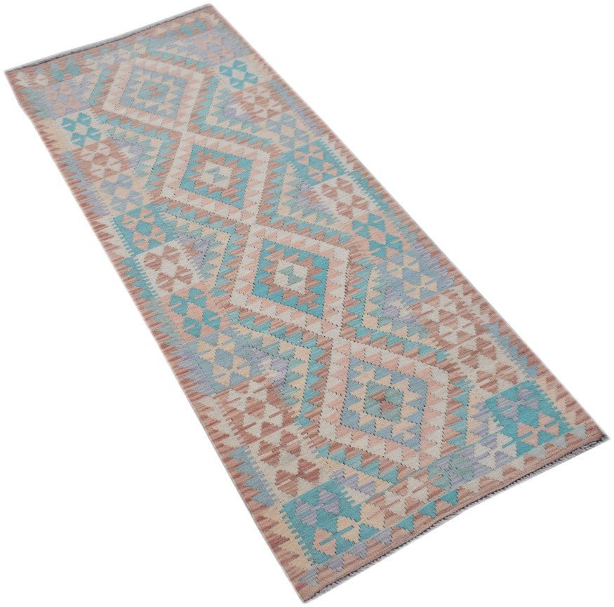 Handmade Afghan Maimana wool runner rug featuring a geometric diamond pattern in pastel tones.