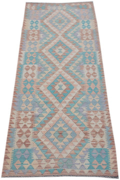Handmade Afghan Maimana wool runner rug featuring a geometric diamond pattern in pastel tones.
