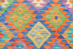Handmade Afghan Maimana kilim runner featuring a vibrant geometric diamond pattern in wool.