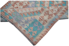 A handmade Afghan Maimana kilim runner featuring a geometric pattern in soft blue and peach tones.