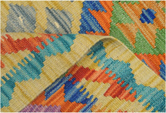 A handmade Afghan Maimana kilim runner featuring vibrant geometric patterns in wool.