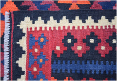 A handmade Afghan Maimana kilim runner featuring geometric patterns in red, blue, and cream wool.