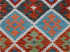 Handwoven Afghan Maimana kilim runner featuring a geometric diamond pattern in vibrant colors.