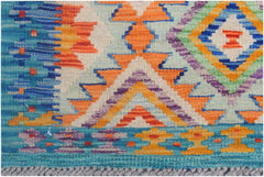 Handmade Afghan Maimana Kilim runner featuring vibrant geometric patterns in wool.