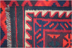 Handwoven Afghan Maimana kilim runner featuring geometric patterns in red, blue, and cream wool.