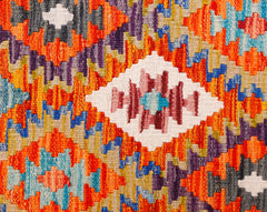 Handwoven Afghan Maimana wool kilim runner featuring a vibrant geometric pattern.