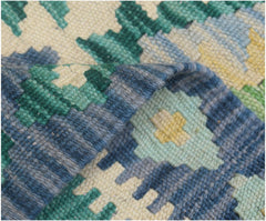 A close-up of a handmade Afghan Maimana kilim runner featuring geometric patterns in wool.