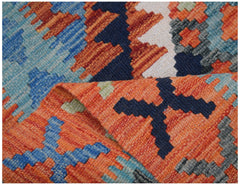 A handwoven Afghan Maimana kilim runner featuring a vibrant geometric pattern in wool.