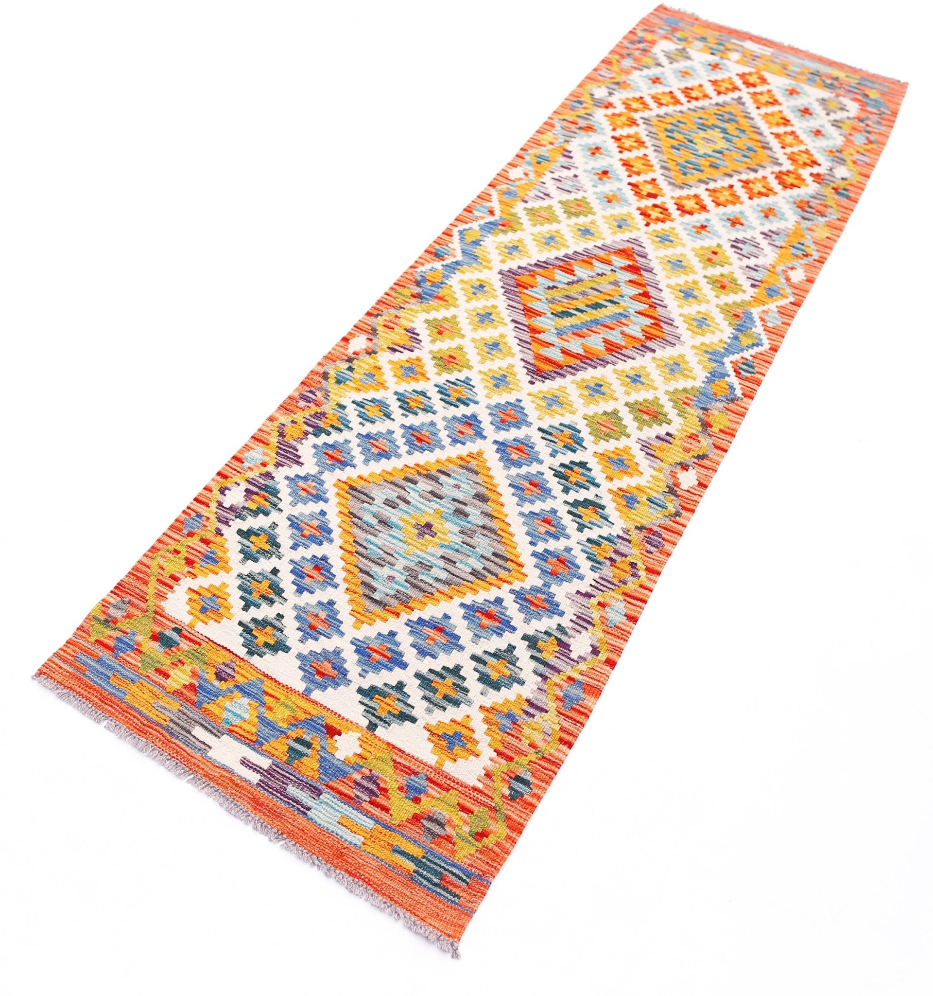 A handmade Afghan Maimana wool runner rug featuring a colorful geometric diamond pattern.