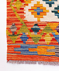Handwoven Afghan Maimana wool runner featuring a vibrant geometric pattern and fringed edges.