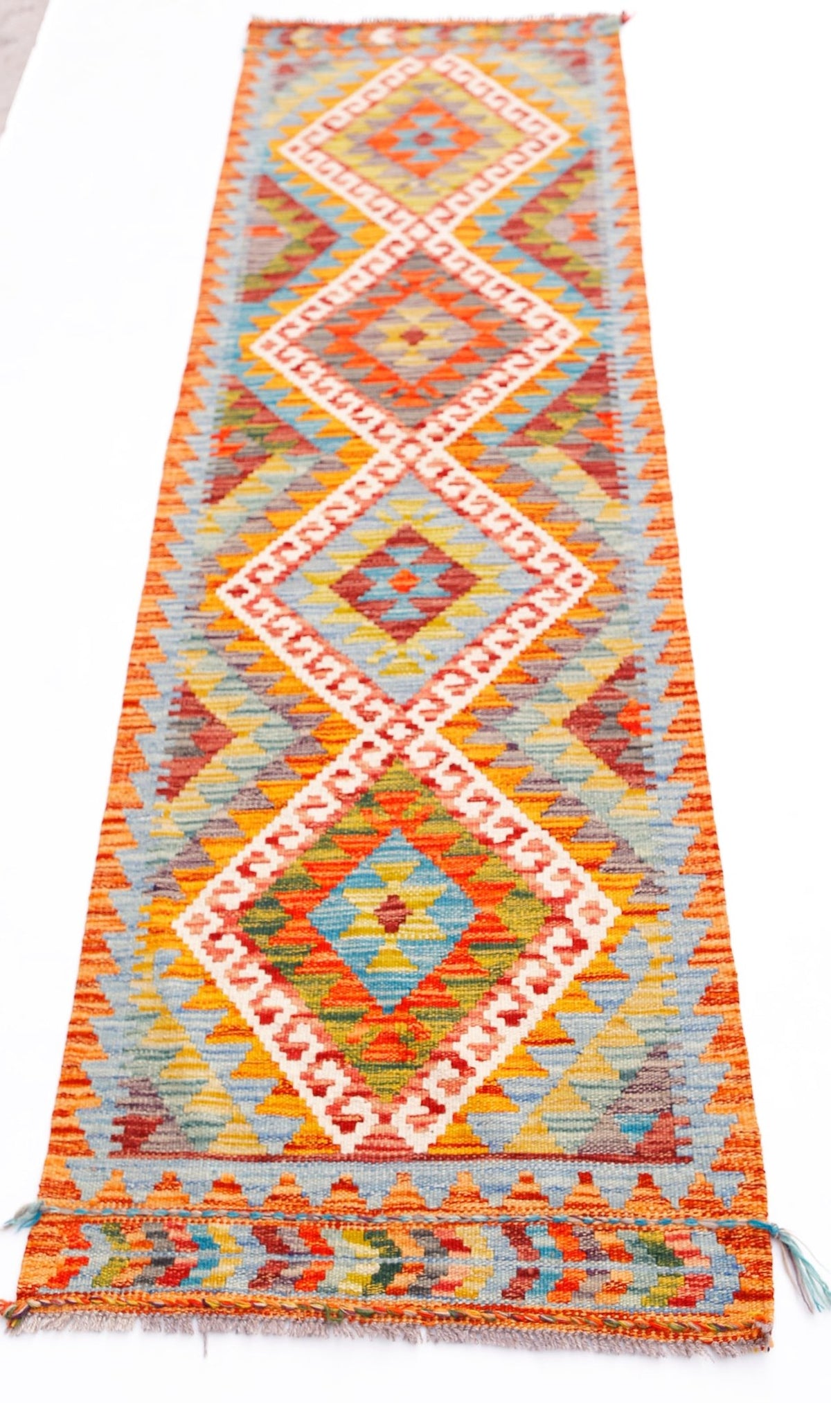 Handwoven Afghan Maimana wool runner featuring a vibrant geometric diamond pattern.