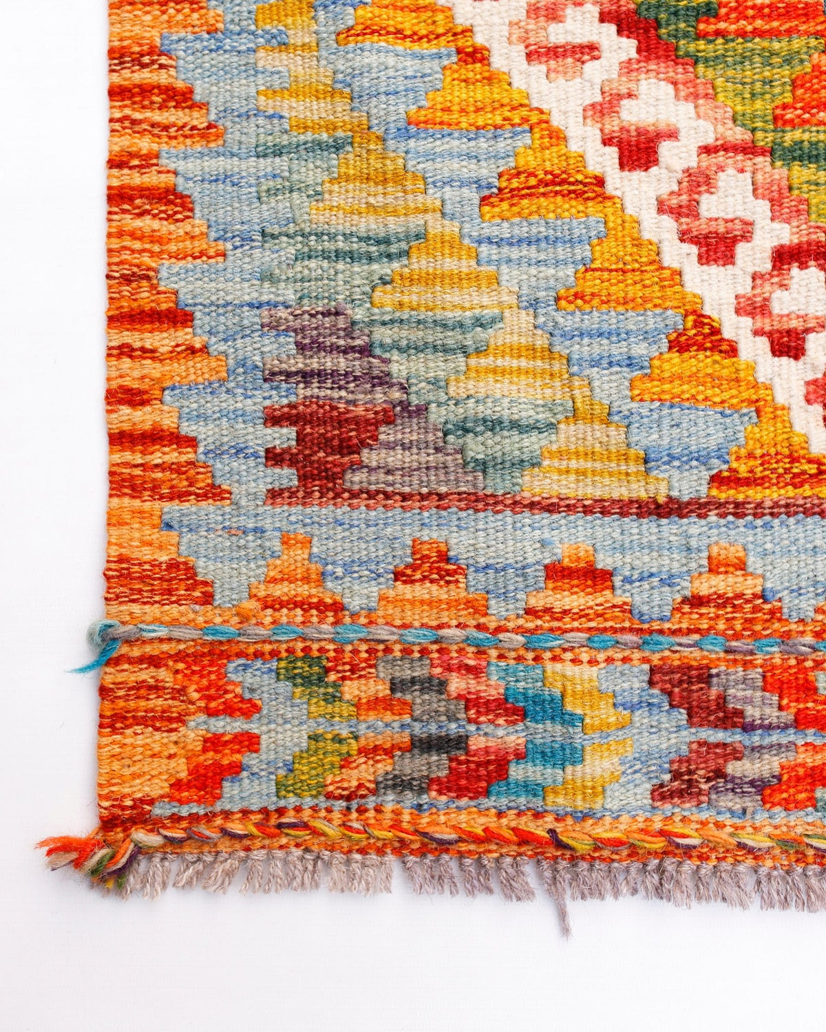 Handwoven Afghan Maimana wool runner featuring a vibrant geometric pattern in a flatweave style.