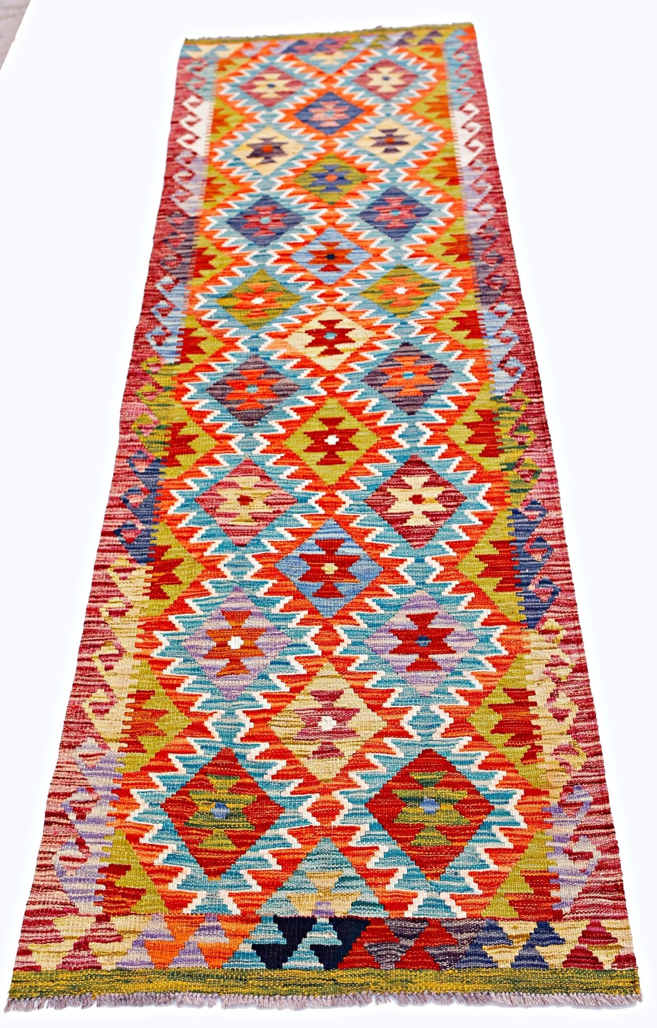 Handwoven Afghan Maimana wool runner rug featuring a vibrant geometric diamond pattern.