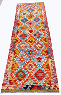 Handwoven Afghan Maimana wool runner rug featuring a vibrant geometric diamond pattern.