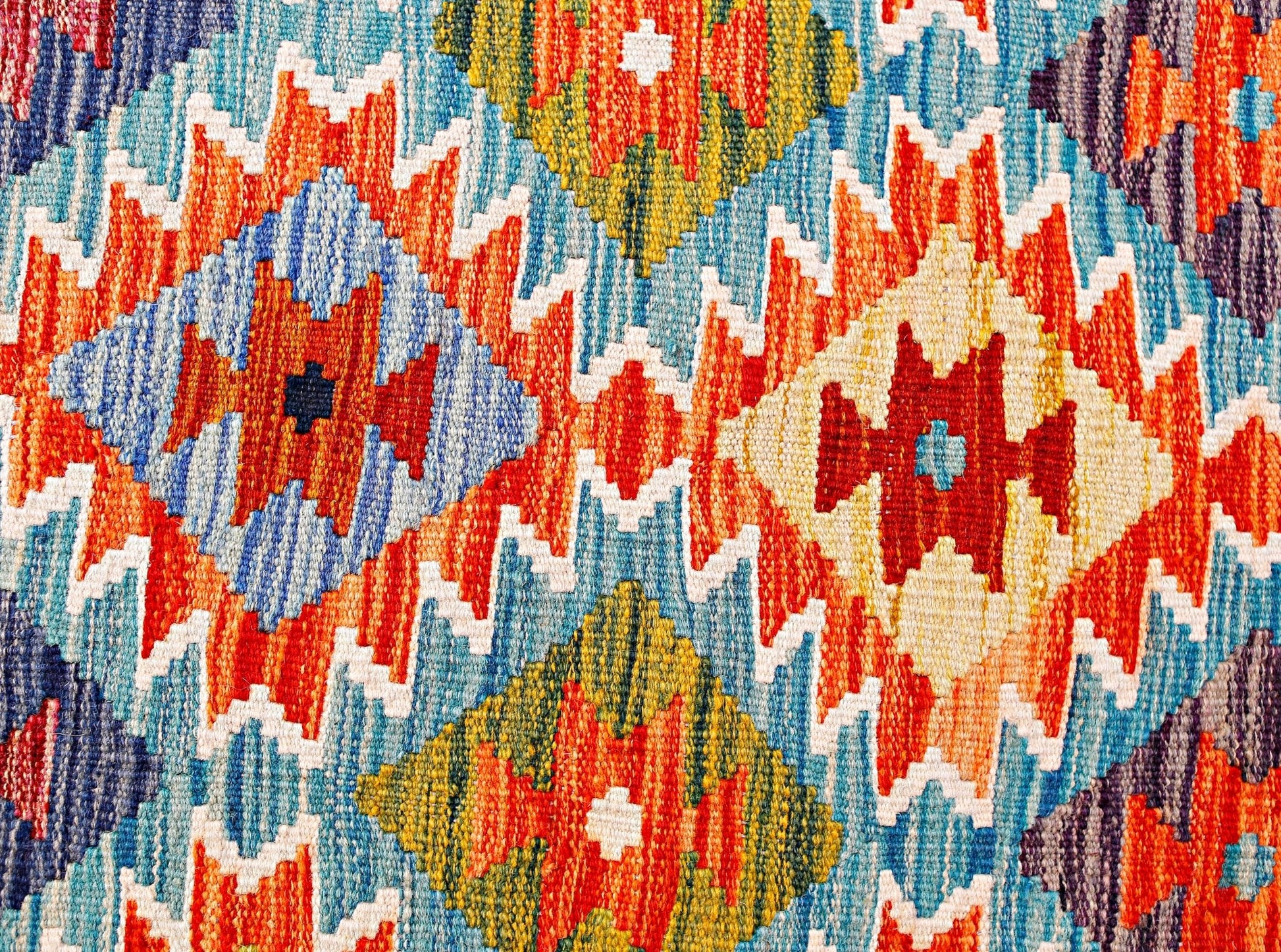 Handwoven Afghan Maimana kilim runner featuring a vibrant geometric diamond pattern in wool.