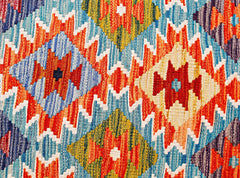 Handwoven Afghan Maimana kilim runner featuring a vibrant geometric diamond pattern in wool.