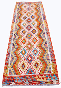 Handwoven Afghan Maimana wool runner featuring a vibrant geometric diamond pattern.