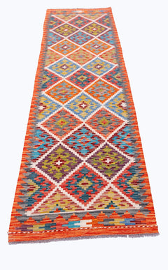 Handwoven Afghan Maimana wool runner featuring a vibrant geometric diamond pattern.