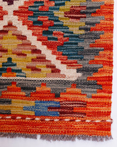 Handwoven Afghan Maimana wool runner featuring a vibrant geometric pattern in a flatweave style.