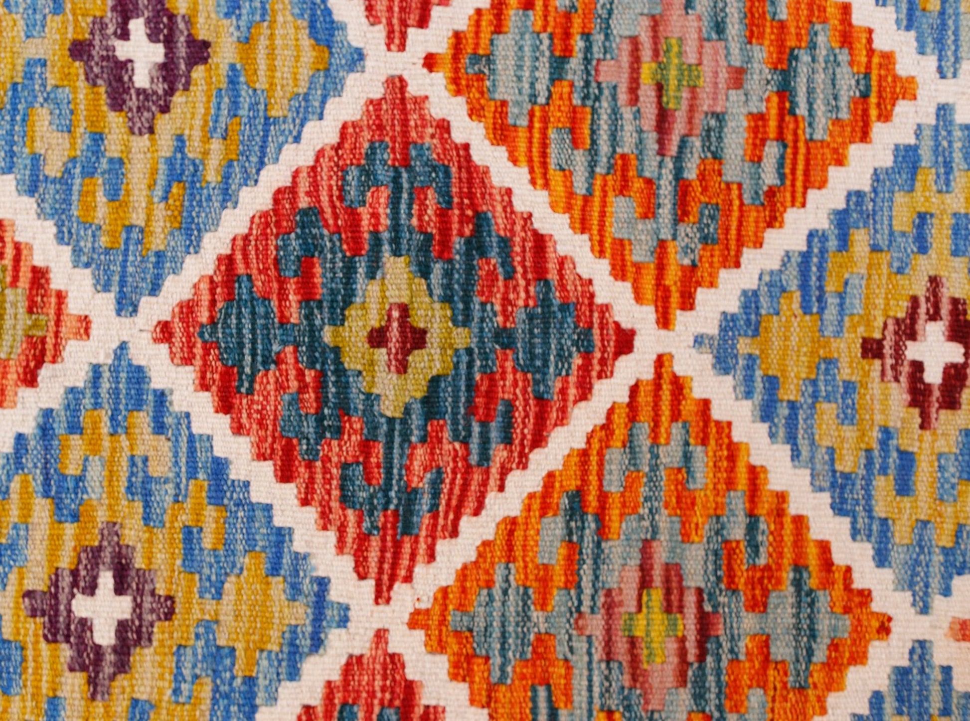 Handwoven Afghan Maimana kilim runner featuring a vibrant geometric diamond pattern in wool.