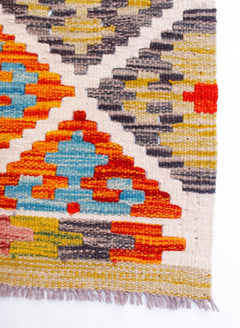 Handwoven Afghan Maimana wool runner featuring a geometric pattern in vibrant multi-colored tones.