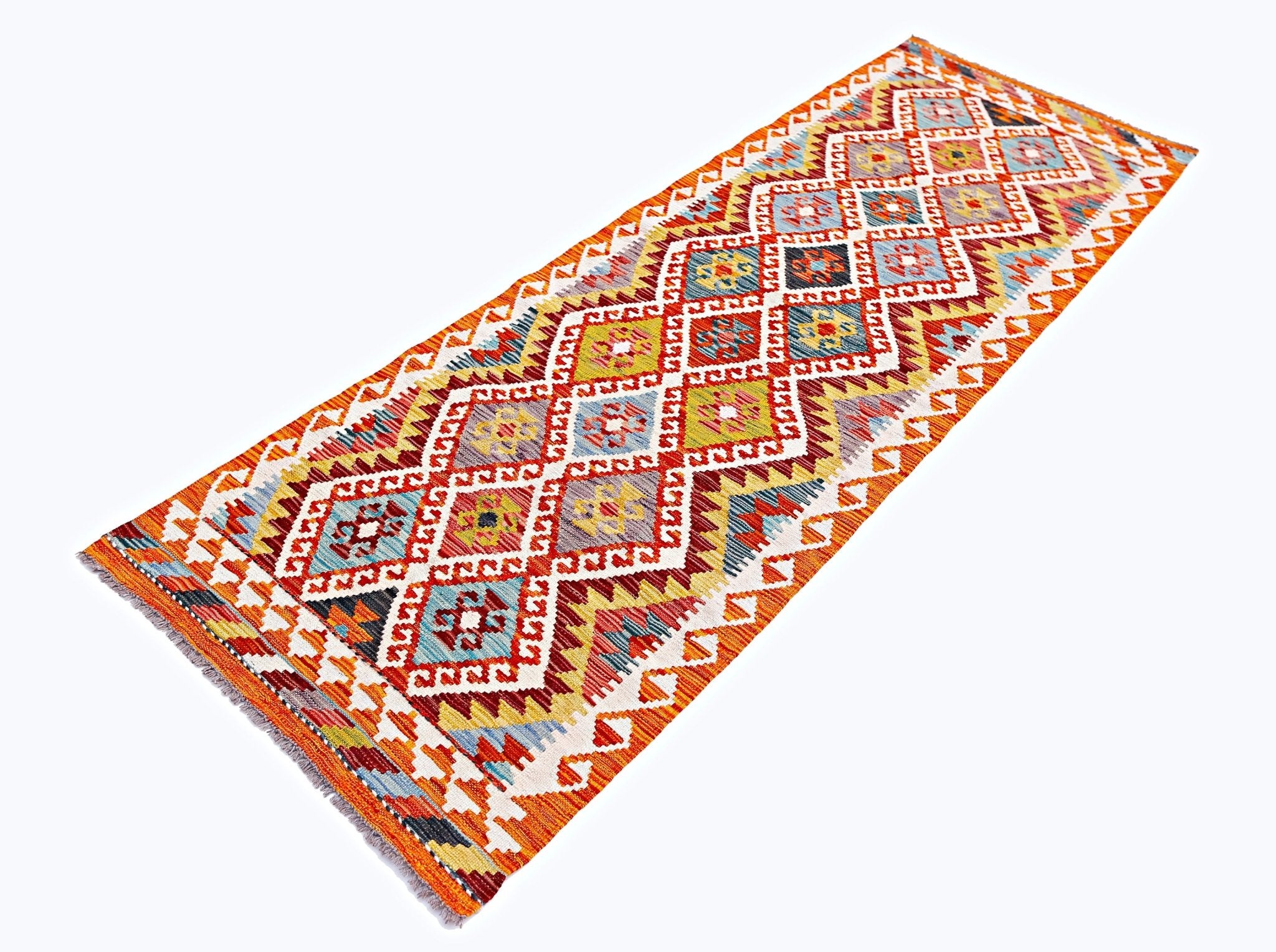 A handmade Afghan Maimana wool runner rug featuring a vibrant geometric diamond pattern.