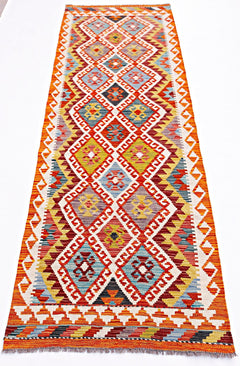 Handwoven Afghan Maimana wool runner rug featuring a colorful geometric diamond pattern.