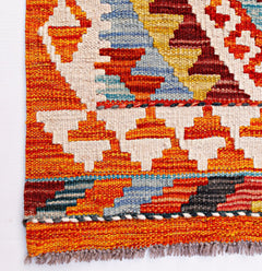 Handwoven Afghan Maimana wool kilim runner featuring a vibrant geometric pattern and fringe ends.