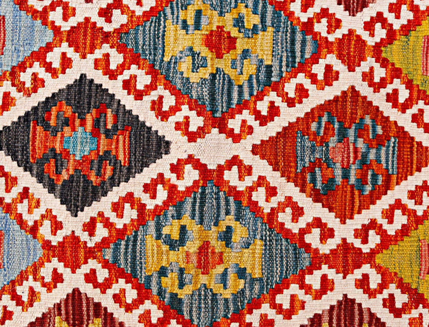 Handwoven Afghan Maimana kilim runner featuring a vibrant geometric diamond pattern in wool.