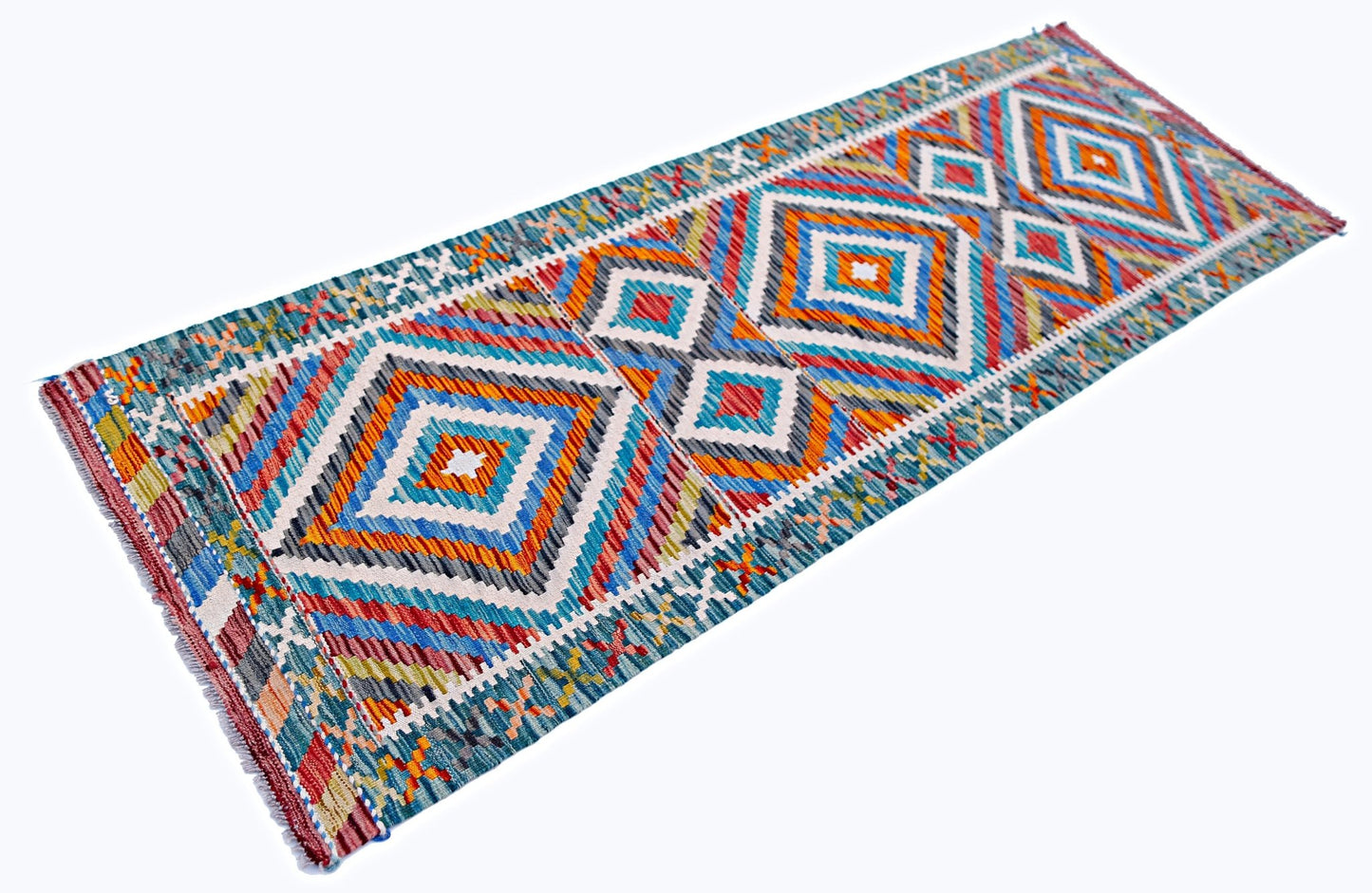 A handmade Afghan Maimana wool runner rug featuring a vibrant geometric diamond pattern.