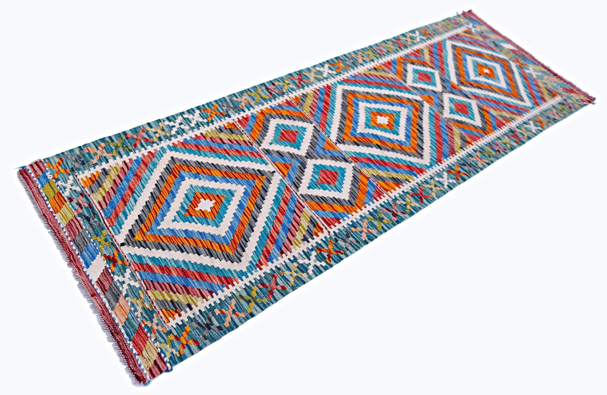 A handmade Afghan Maimana wool runner rug featuring a vibrant geometric diamond pattern.